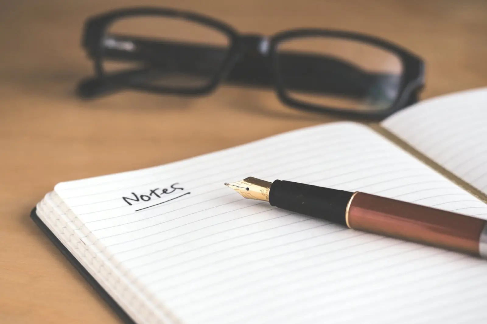 An open notebook and pen on a desk during a planning review